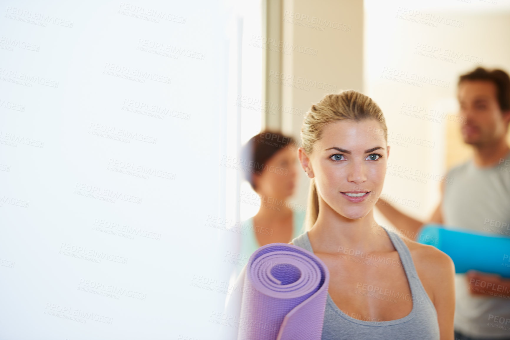 Buy stock photo Fitness woman after a yoga class holding her exercise mat. Sporty female ready for her workout at a fitness training centre. Active yogi ready for exercise and to enjoy sporty hobby at gym