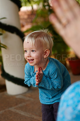 Buy stock photo Cute little boy adorned with a bindi on his forehead, bowing in a Hindu temple 