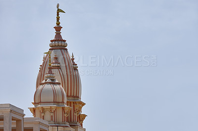 Buy stock photo Temple, spire and space in sky for religion, worship and travel wallpaper in India. Naba Brindaban, culture and architecture in city for Hinduism, spiritual atmosphere and Holy building for praise