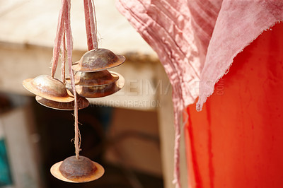 Buy stock photo Worn brass hand cymbals hanging alongside colorful cloth