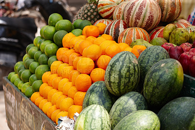 Buy stock photo Stacked rows of fresh fruit - limes, oranges and melons - in an Indian market