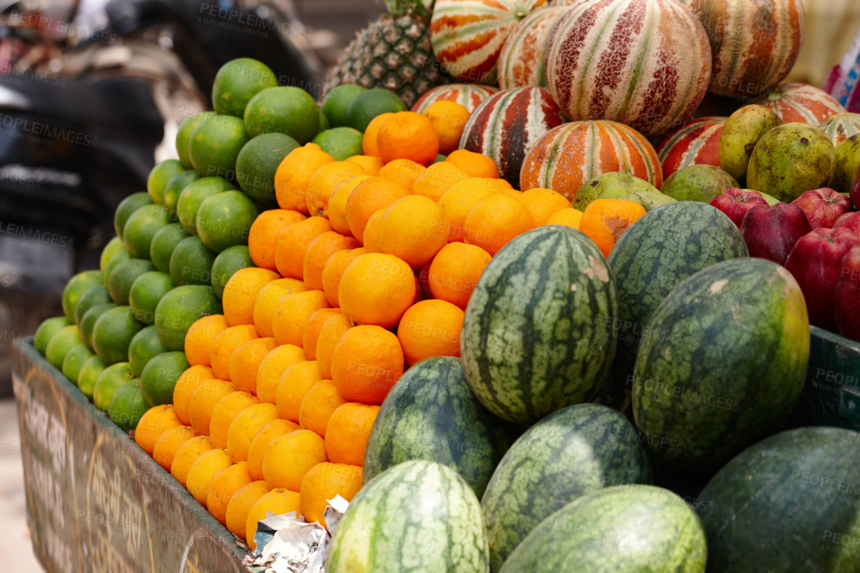 Buy stock photo Stacked rows of fresh fruit - limes, oranges and melons - in an Indian market