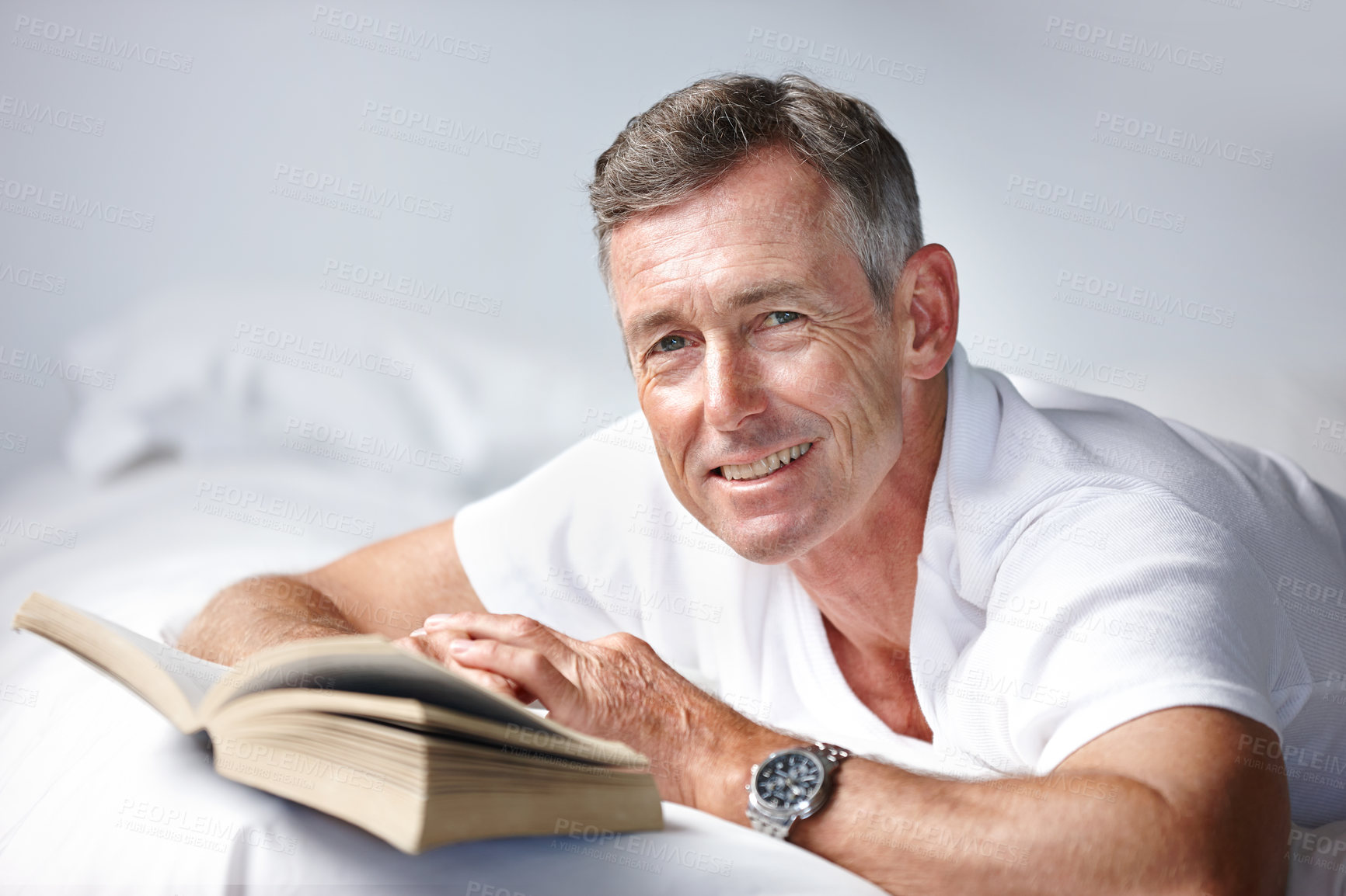 Buy stock photo Portrait of a mature man reading a book in bed