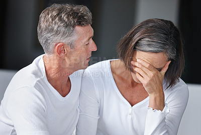 Buy stock photo Shot of a mature man sitting beside his wife who's feeling depressed