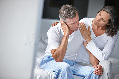 Buy stock photo Shot of a mature woman consoling her husband who's feeling depressed