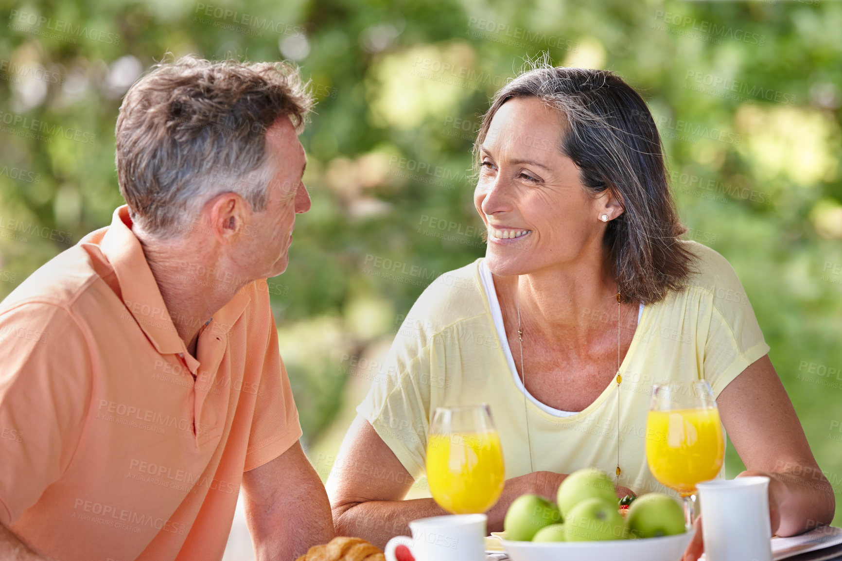 Buy stock photo Outdoor, breakfast and senior couple with love, smile and bonding together with conversation. Happiness, mature man and woman with care, nutrition and healthy meal with protein, diet and vitamins