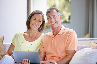 Buy stock photo Portrait of a loving mature couple relaxing with a digital tablet at home