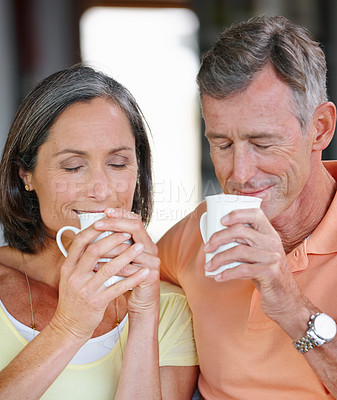Buy stock photo Shot of a  loving mature couple having coffee together at home