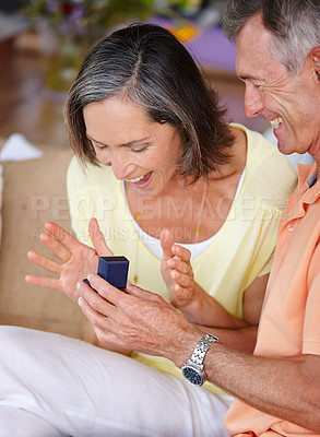 Buy stock photo Shot of a mature man proposing to his girlfriend at home