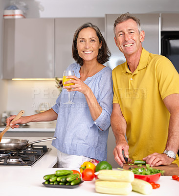 Buy stock photo Portrait of a mature couple preparing a meal together in the kitchen