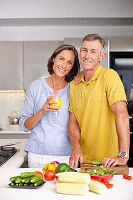 Buy stock photo Portrait of a loving mature couple standing beside each other in the kitchen