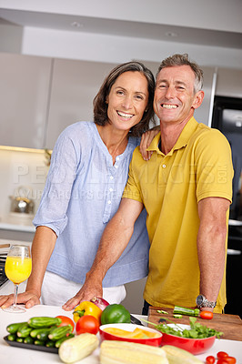 Buy stock photo Portrait of a loving mature couple standing beside each other in the kitchen