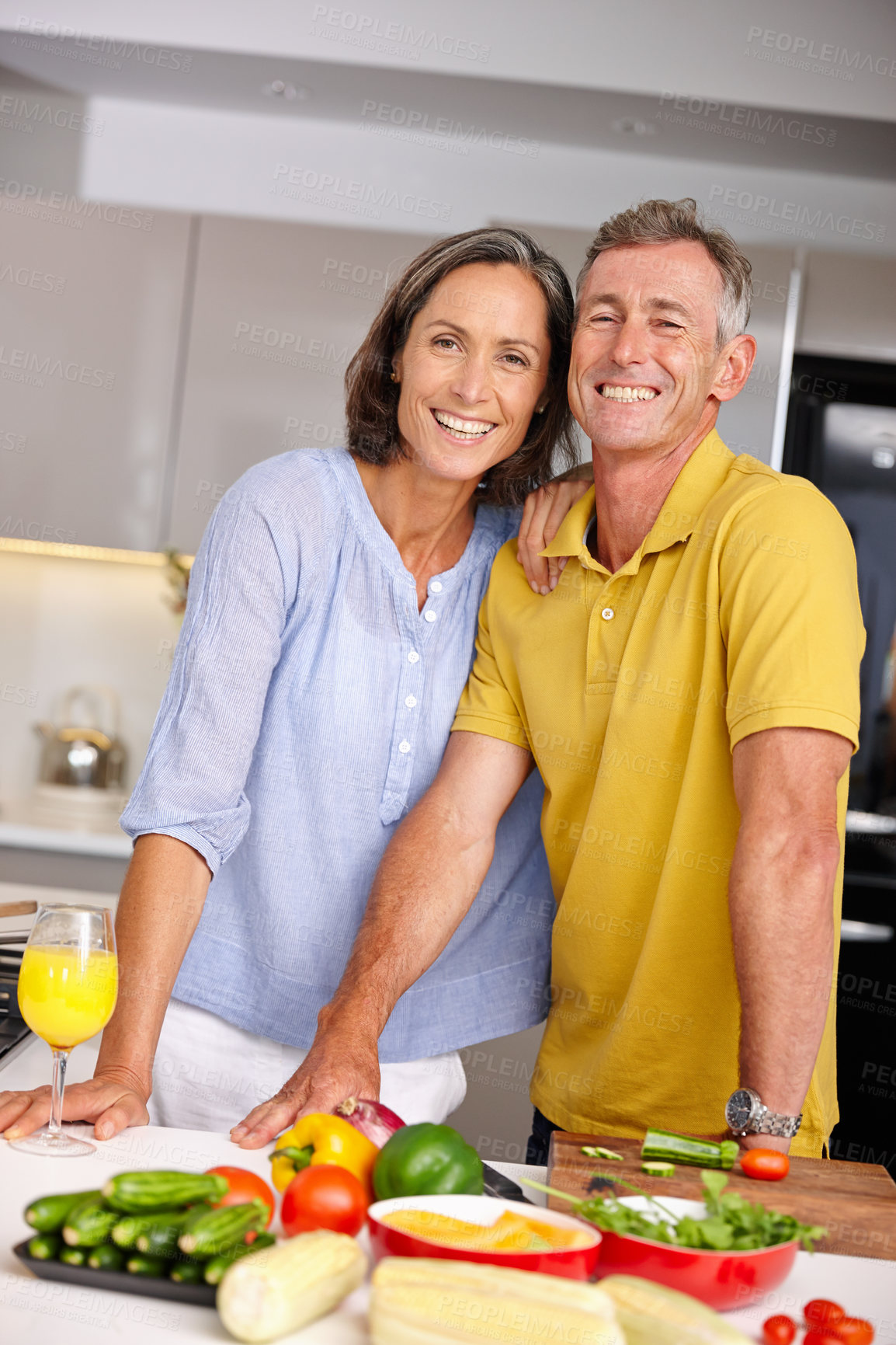 Buy stock photo Portrait of a loving mature couple standing beside each other in the kitchen