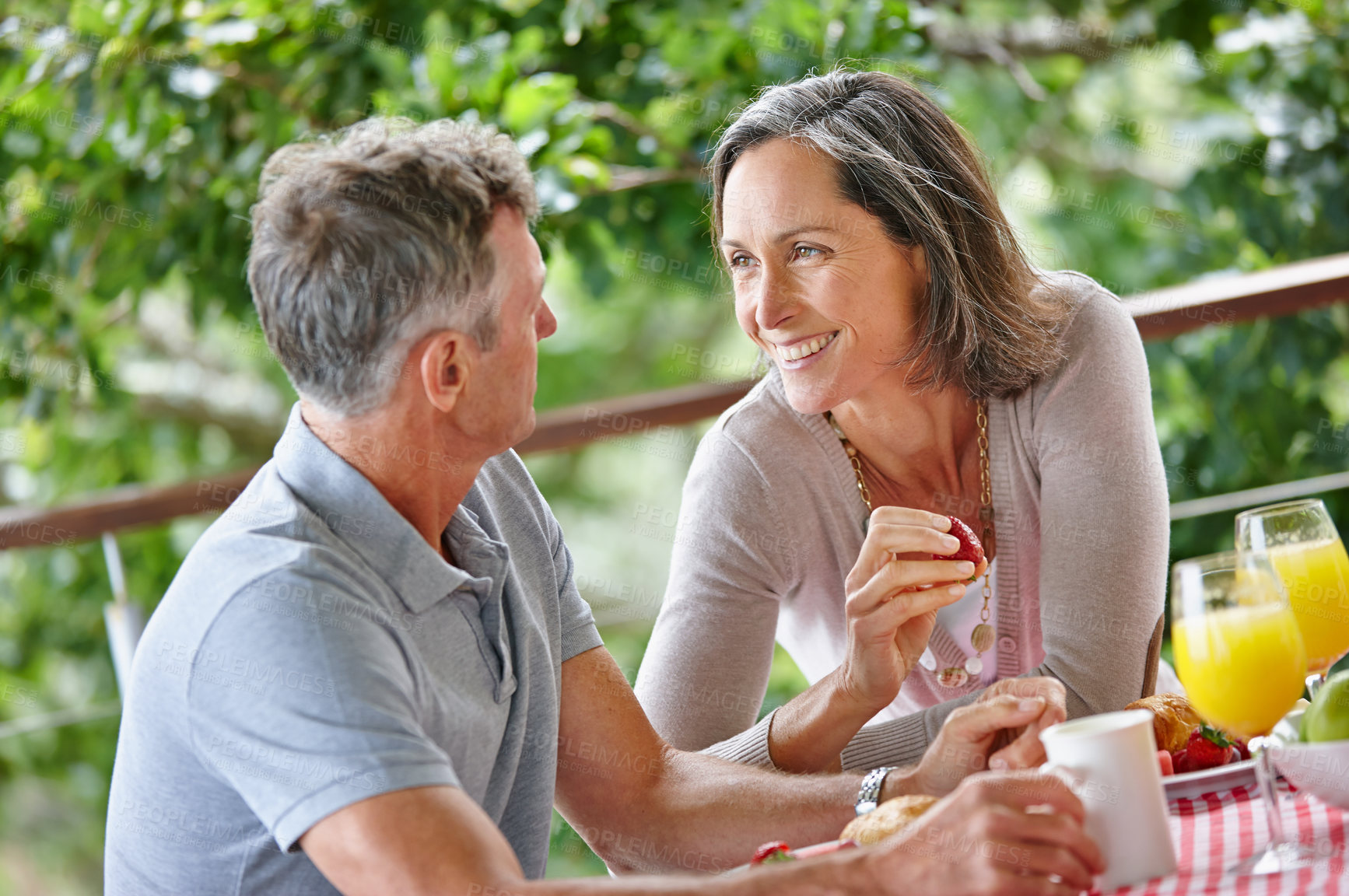 Buy stock photo Outdoor, breakfast and senior couple with smile, talking and bonding together with conversation. Happiness, mature man and woman with love, nutrition and healthy meal with protein, diet and vitamins