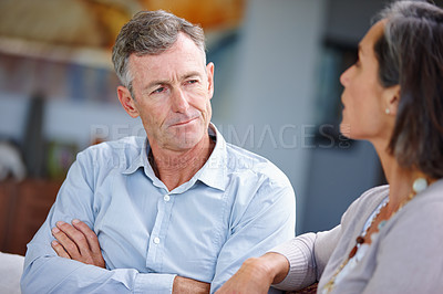Buy stock photo Shot of a mature married couple having an argument at home