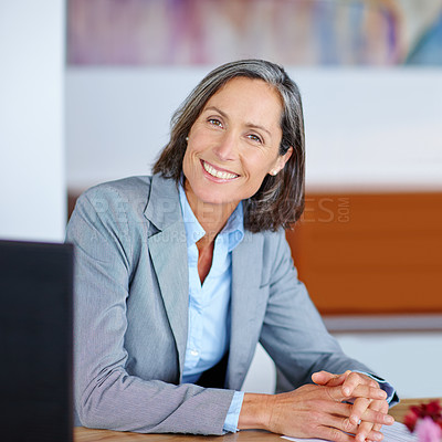 Buy stock photo Portrait of a mature businesswoman sitting at her office desk