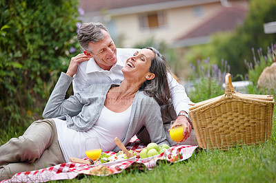 Buy stock photo Mature, couple and relax for picnic outdoor with healthy fruit, bonding together and food basket of romantic date. People, laugh and love with juice of relationship anniversary, commitment and nature