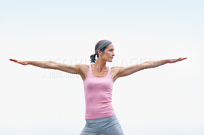 Buy stock photo Shot of an attractive mature woman doing yoga outdoors