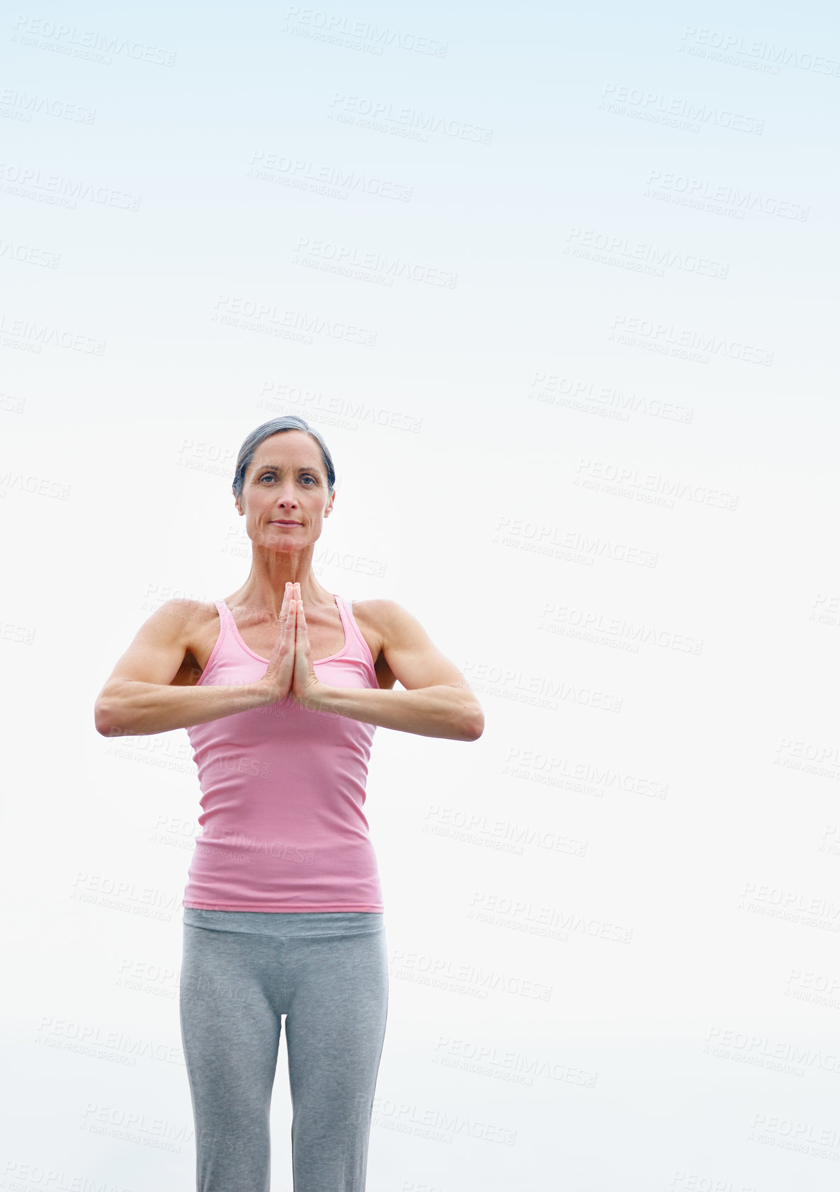 Buy stock photo Shot of an attractive mature woman doing yoga outdoors