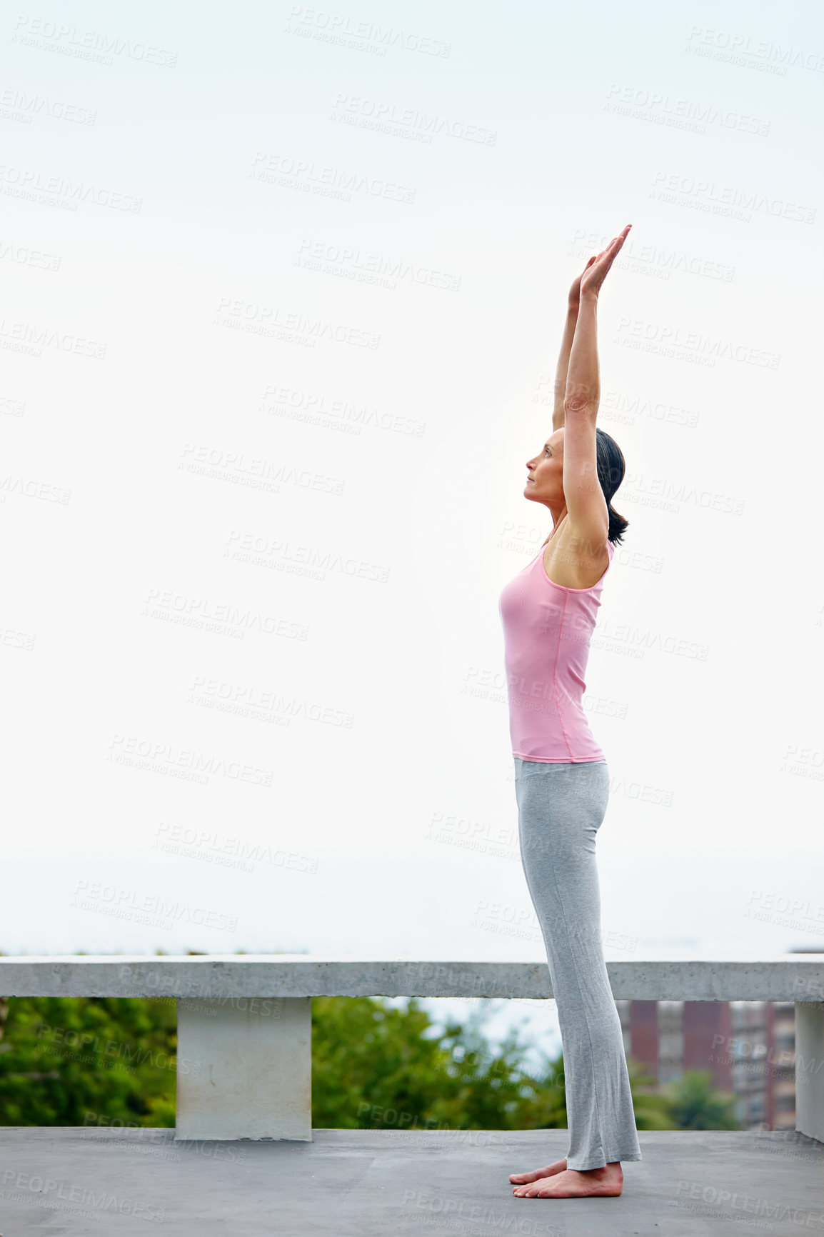 Buy stock photo Shot of an attractive mature woman doing yoga outdoors