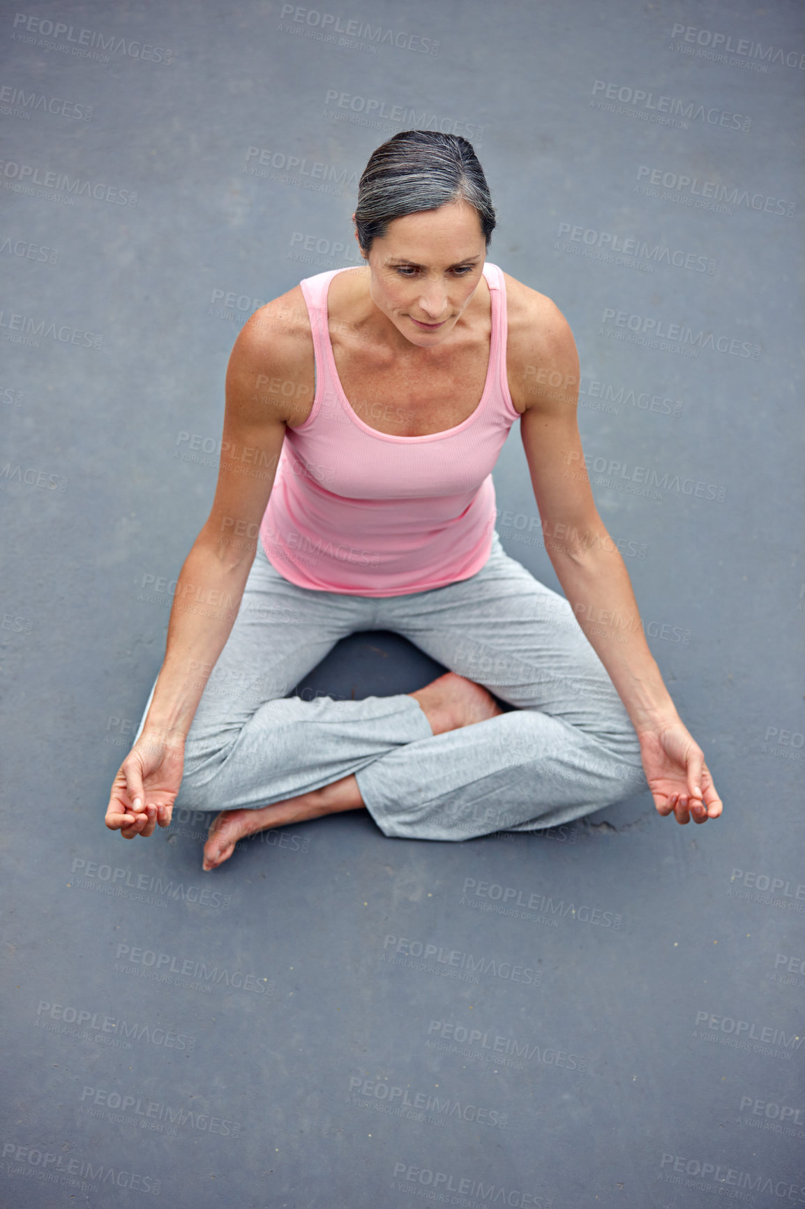 Buy stock photo Shot of an attractive mature woman practicing yoga in the lotus position