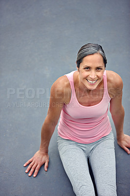 Buy stock photo High angle view of an attractive mature woman doing yoga outdoors