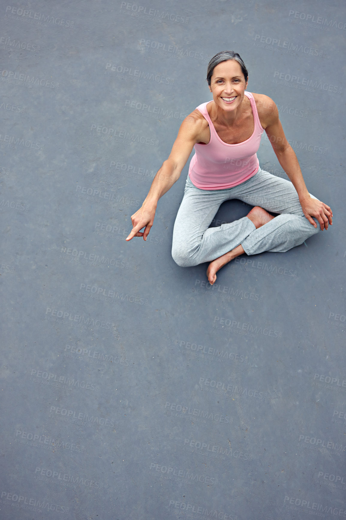 Buy stock photo High angle portrait of an attractive mature woman in gymwear pointing at copyspace