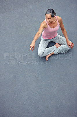 Buy stock photo High angle shot of an attractive mature woman in gymwear pointing at copyspace