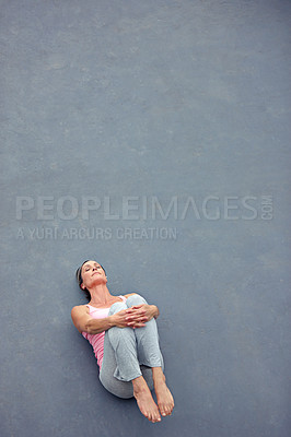 Buy stock photo High angle view of an attractive mature woman doing yoga outdoors