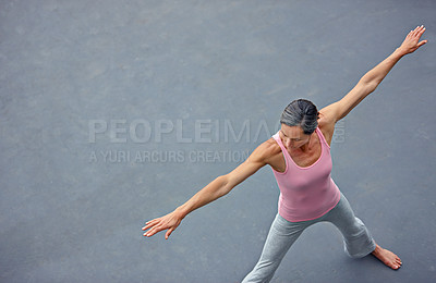 Buy stock photo High angle shot of an attractive mature woman doing yoga outdoors