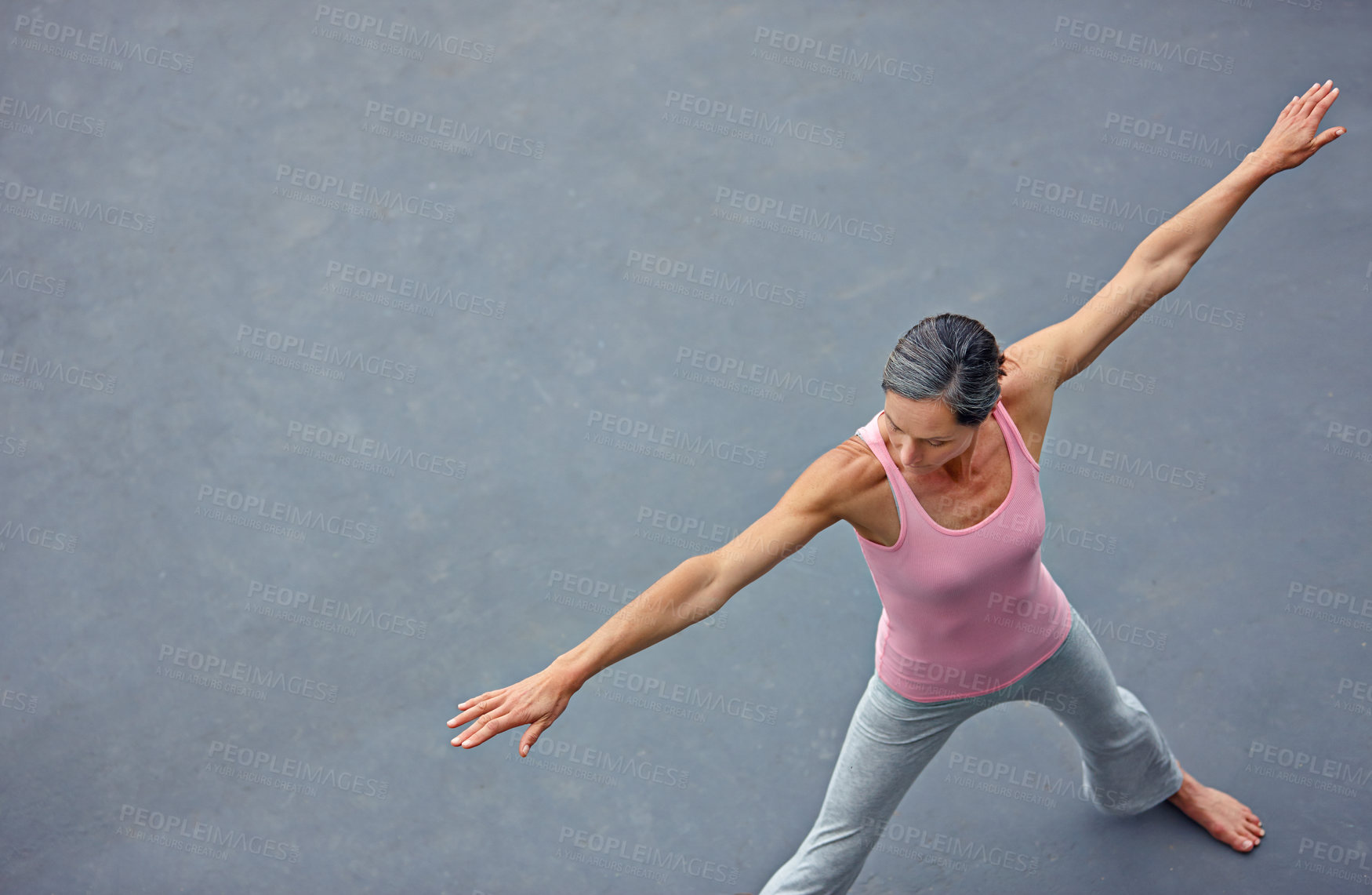 Buy stock photo High angle shot of an attractive mature woman doing yoga outdoors