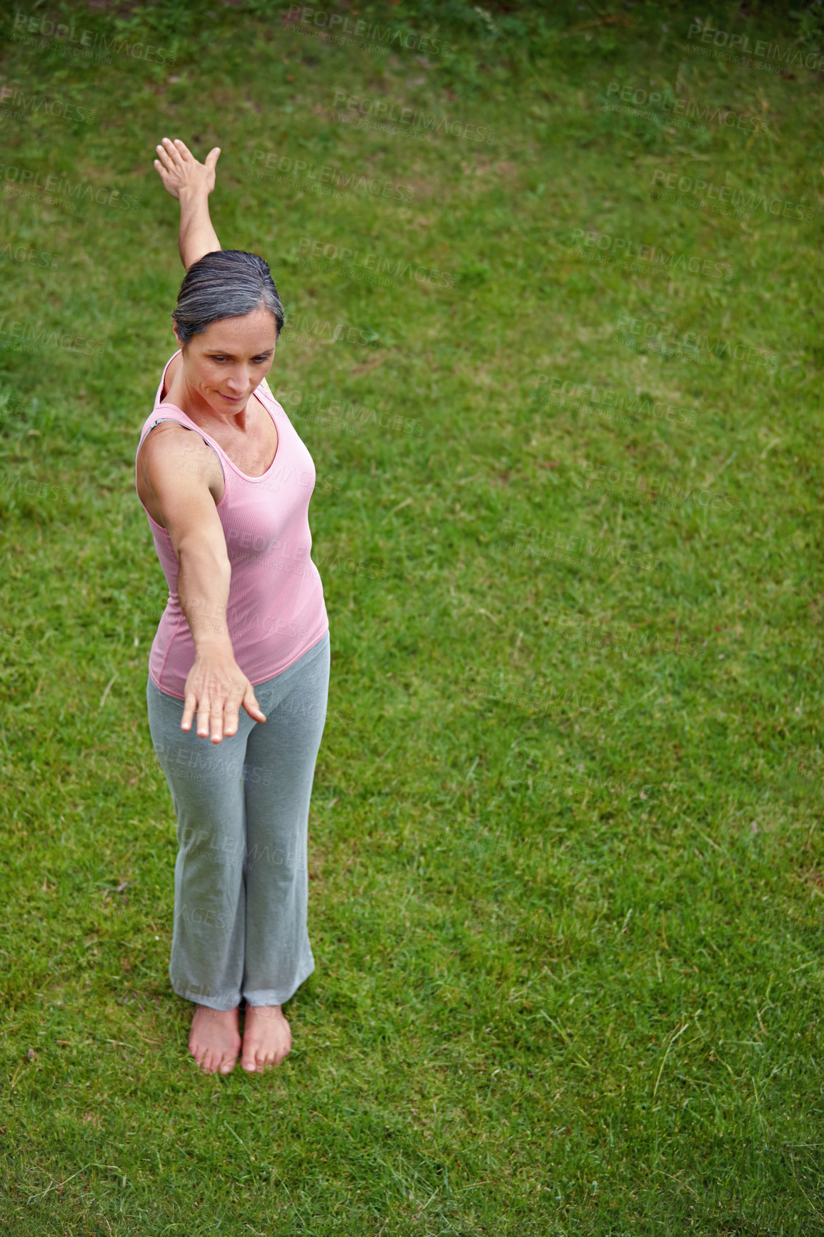 Buy stock photo High angle shot of an attractive mature woman doing yoga outdoors