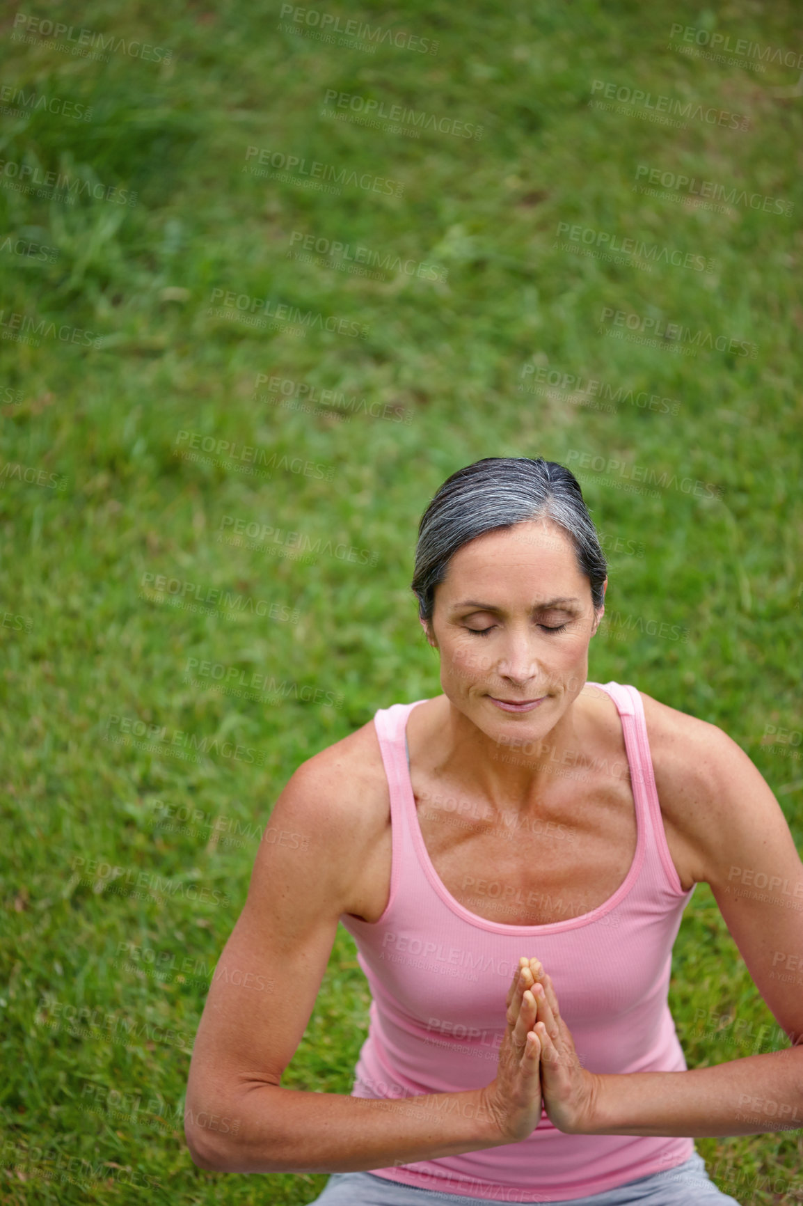 Buy stock photo Shot of an attractive mature woman practicing yoga in the lotus position