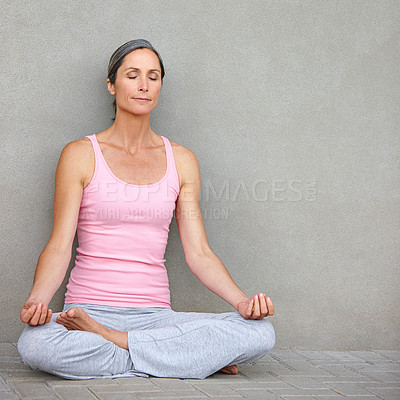 Buy stock photo Woman, yoga and lotus at wall for peace, meditation and wellness with space. Mature fitness person, zen and healthy body in home for spiritual healing, positive mental health and calm to align chakra