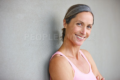 Buy stock photo Gray wall, woman and happy for fitness with pride for exercise, workout or health in Germany. Mature person, smile and mockup space for yoga as hobby or activity for wellness or self care on portrait