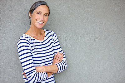 Buy stock photo Arms crossed, portrait and smile with mature woman on gray background in studio for trendy style. Clothes, fashion and stripes with happy person on empty mockup space to model outfit or wardrobe