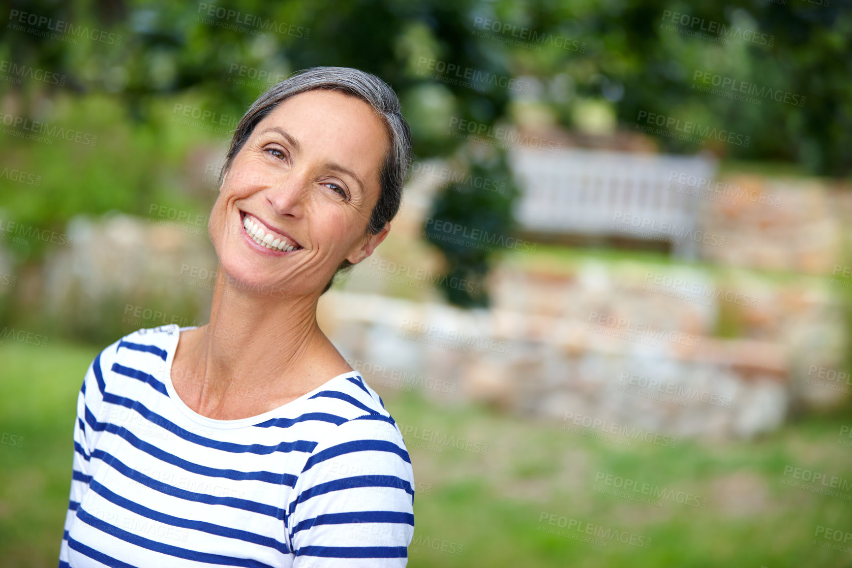 Buy stock photo Mature woman, smile and portrait in garden, nature and excited in backyard with sunshine in morning. Person, happy and outdoor with confidence, pride and break on lawn, summer and blur in Croatia