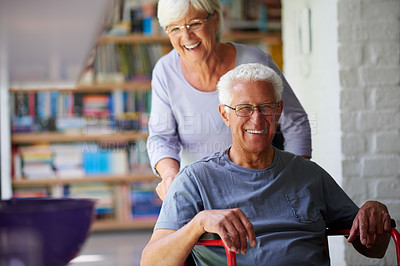 Buy stock photo Portrait of a happy senior man in a wheelchair being helped by his wife