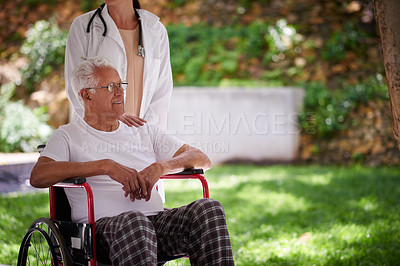 Buy stock photo Cropped shot of a senior man in a wheelchair with his doctor standing behind him