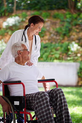 Buy stock photo Shot of a senior man in a wheelchair sharing a joke with his doctor
