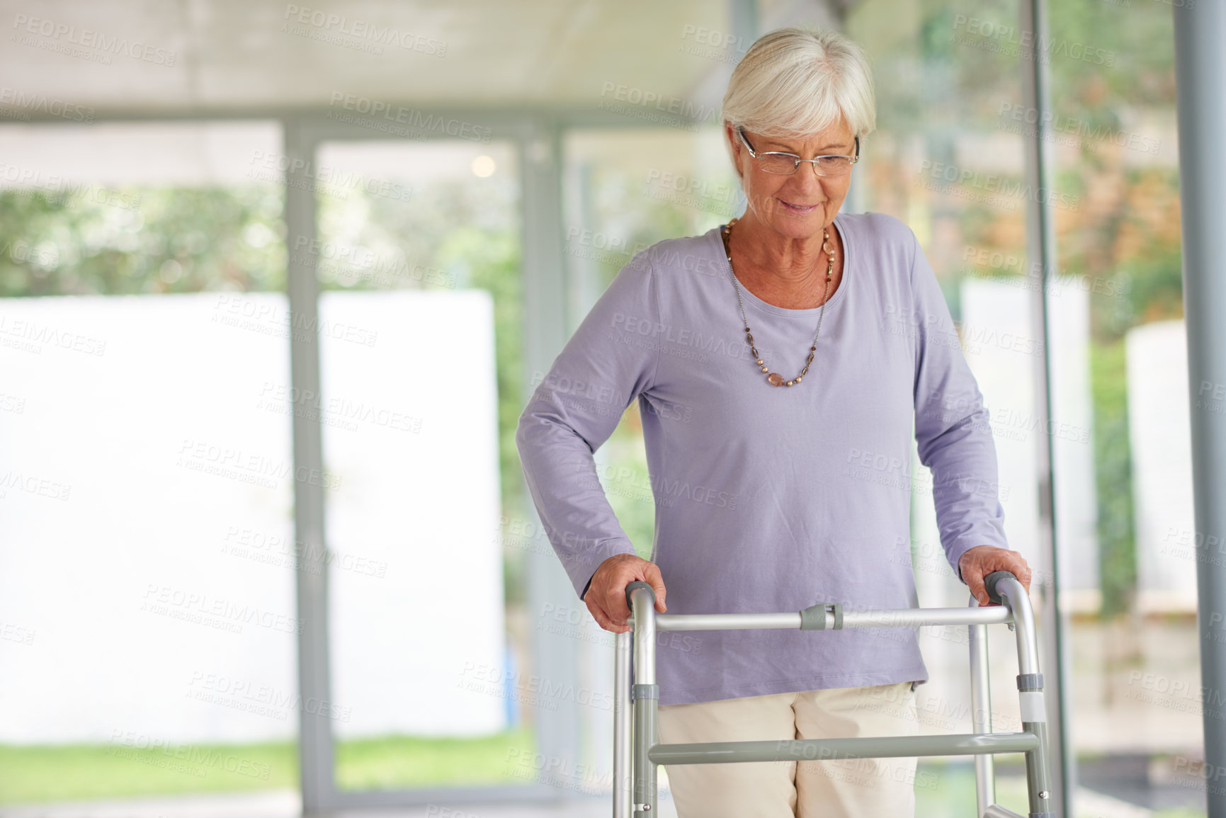 Buy stock photo Senior woman, walker and smile in nursing home for support, balance and rehabilitation progress. Recovery, patient and elderly person with disability for mobility, arthritis pain management and care