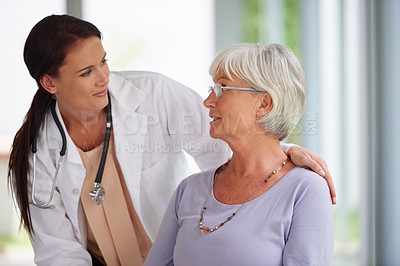 Buy stock photo Shot of young doctor checking up on her senior patient