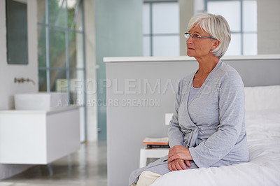 Buy stock photo Shot of a senior woman looking pensive in her room in a private clinic