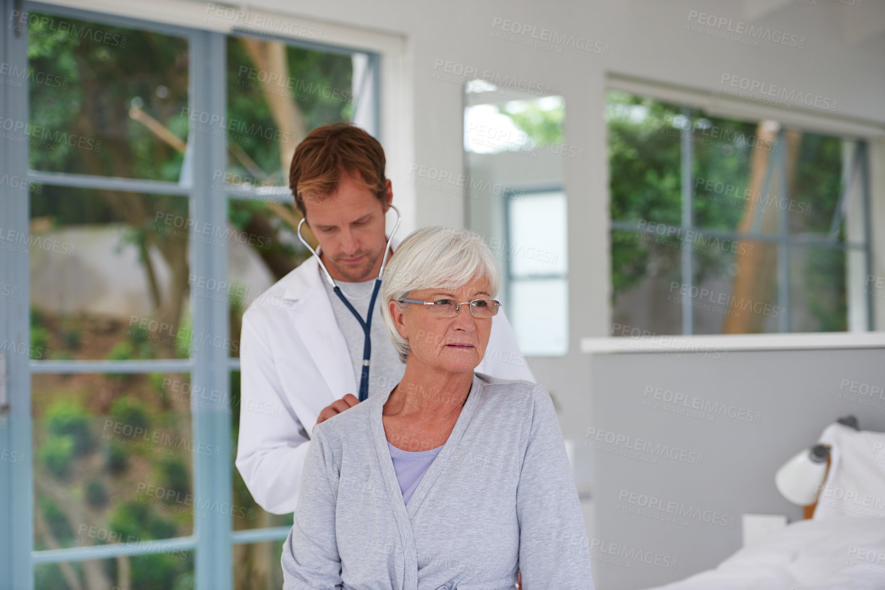 Buy stock photo Shot of a pensive senior woman having a medical check up