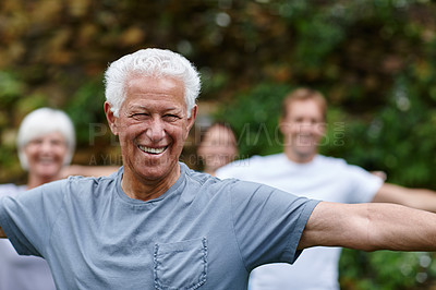Buy stock photo Portrait of a senior man doing yoga with other people outdoors