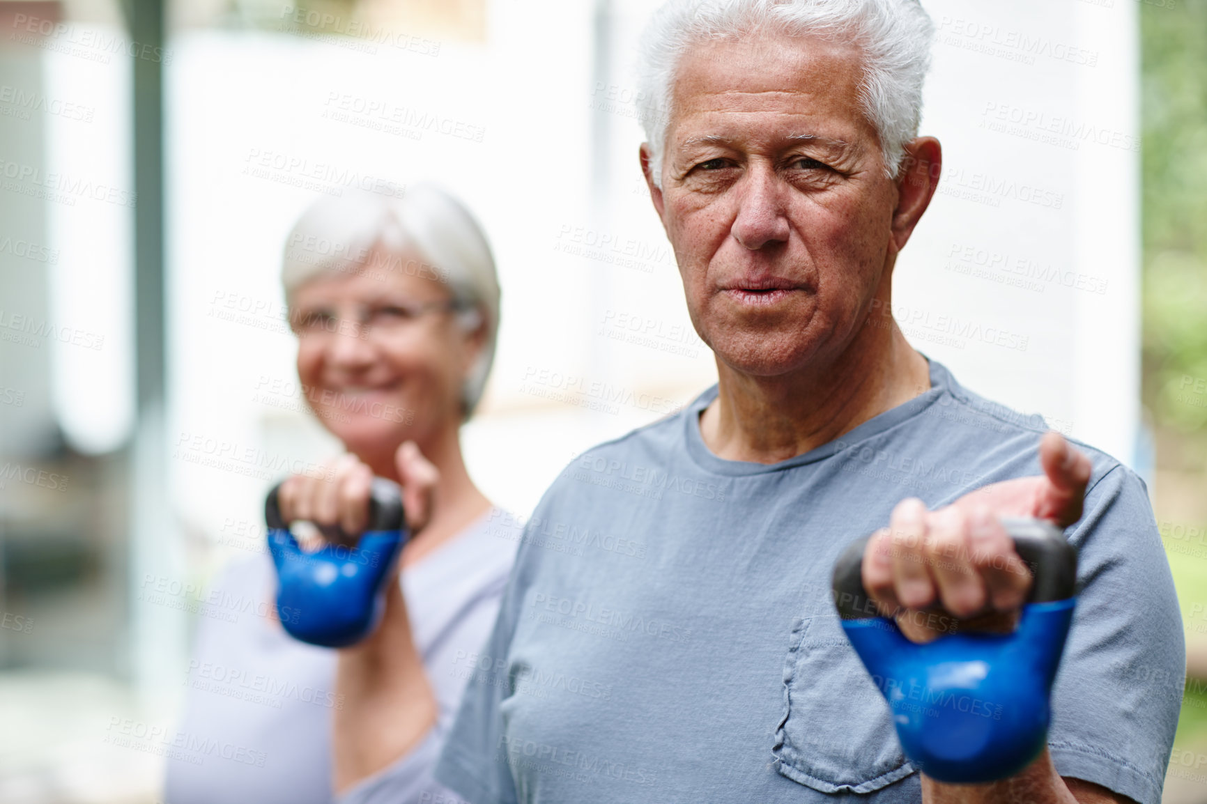 Buy stock photo Old couple, kettlebell and outdoor workout in portrait, exercise and together for mobility. Senior people, lift and fitness for joint flexibility in backyard of home, support and weights for strength