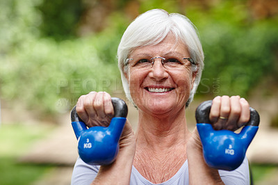 Buy stock photo Portrait of a senior woman training with light weights outdoors