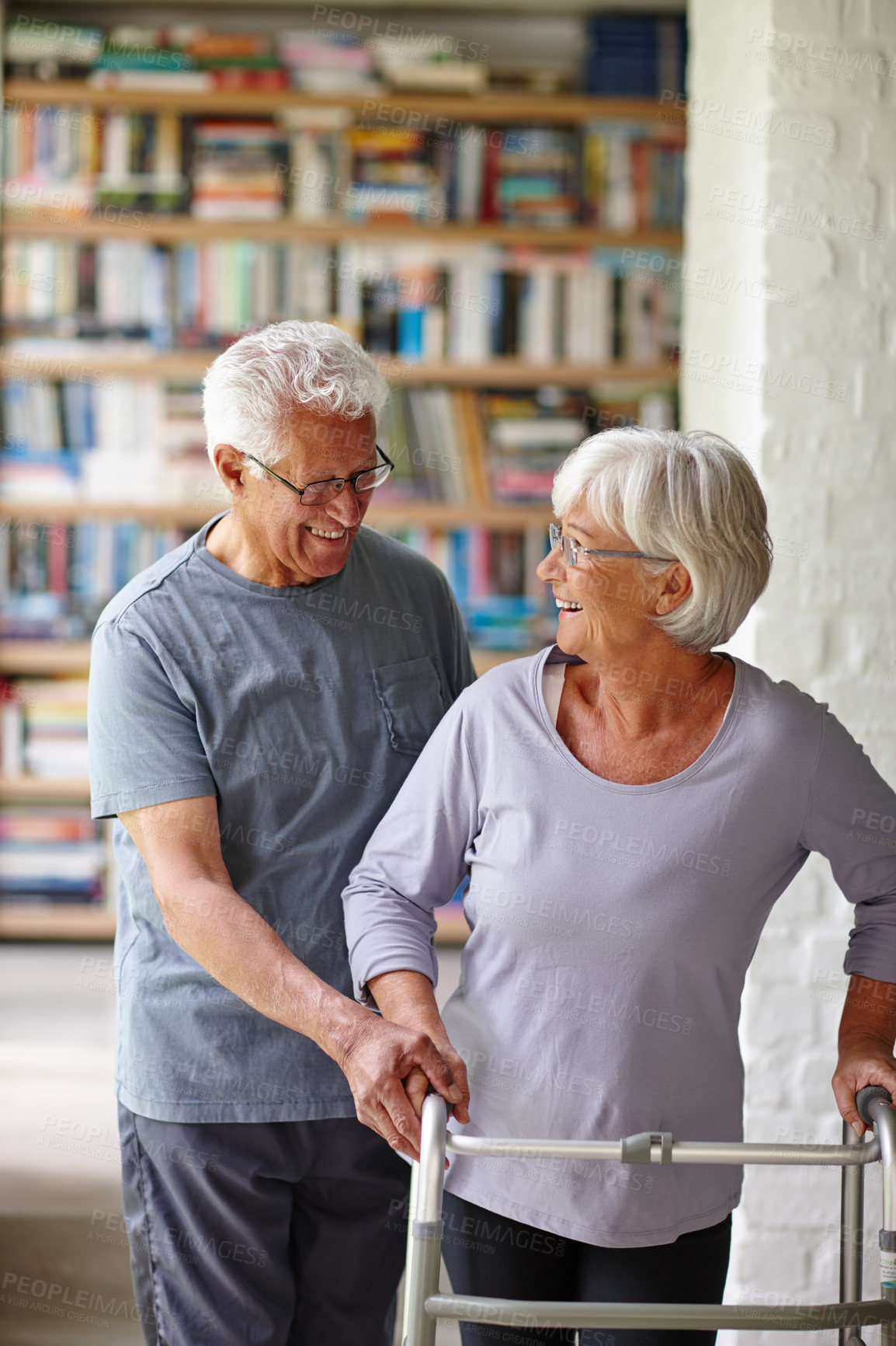 Buy stock photo Elderly couple, smile and walker for help, support or laugh together in home for health. Man, walking frame and assist senior woman with disability in retirement, rehabilitation or physical therapy