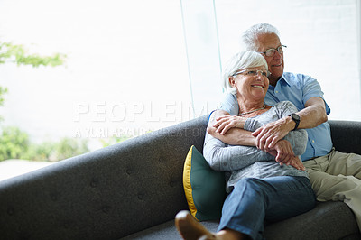 Buy stock photo Shot of a senior couple sitting in their living room