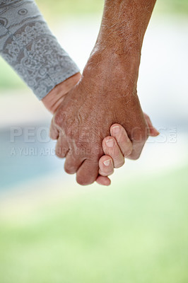 Buy stock photo Senior couple, holding hands and bonding with support for relationship, love or care in nature. Closeup, elderly people or pensioners with touch or help for togetherness, dating or walk in retirement